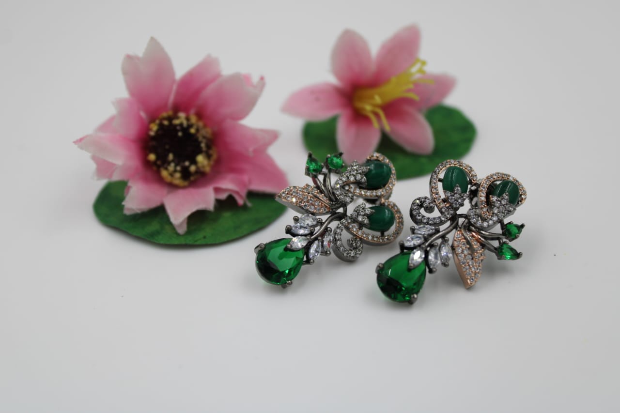 Fancy stud earring with dark green stones