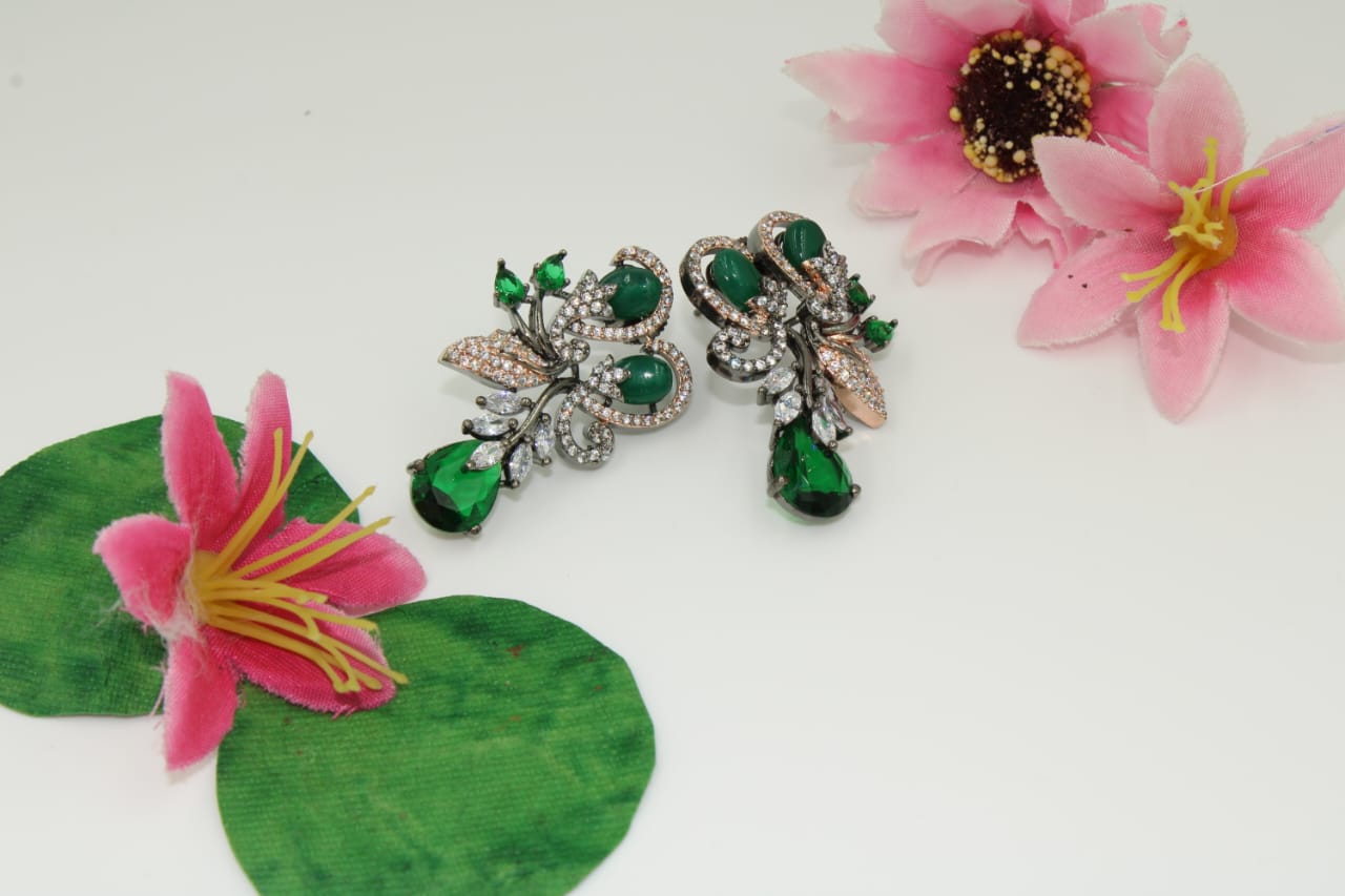 Fancy stud earring with dark green stones