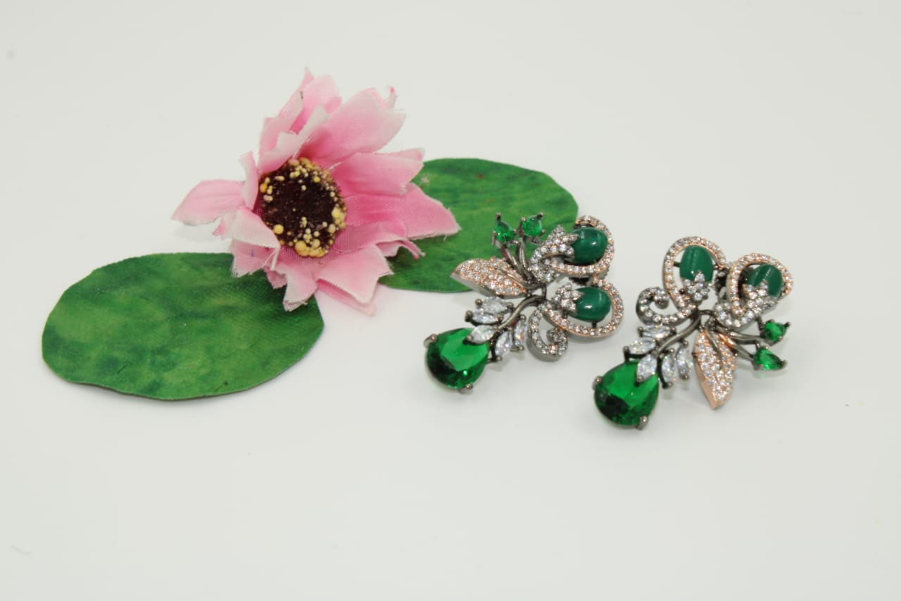 Fancy stud earring with dark green stones