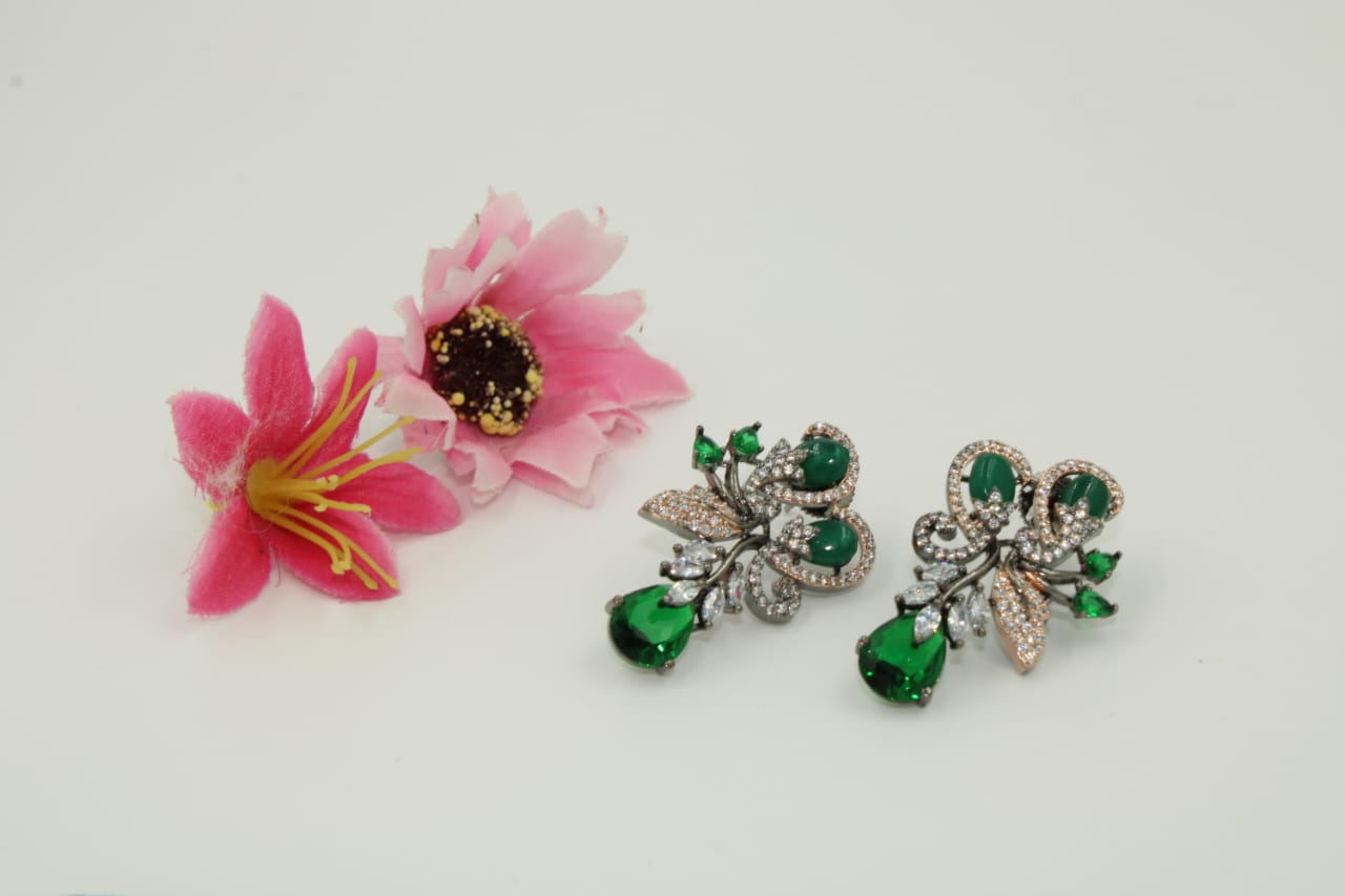 Fancy stud earring with dark green stones