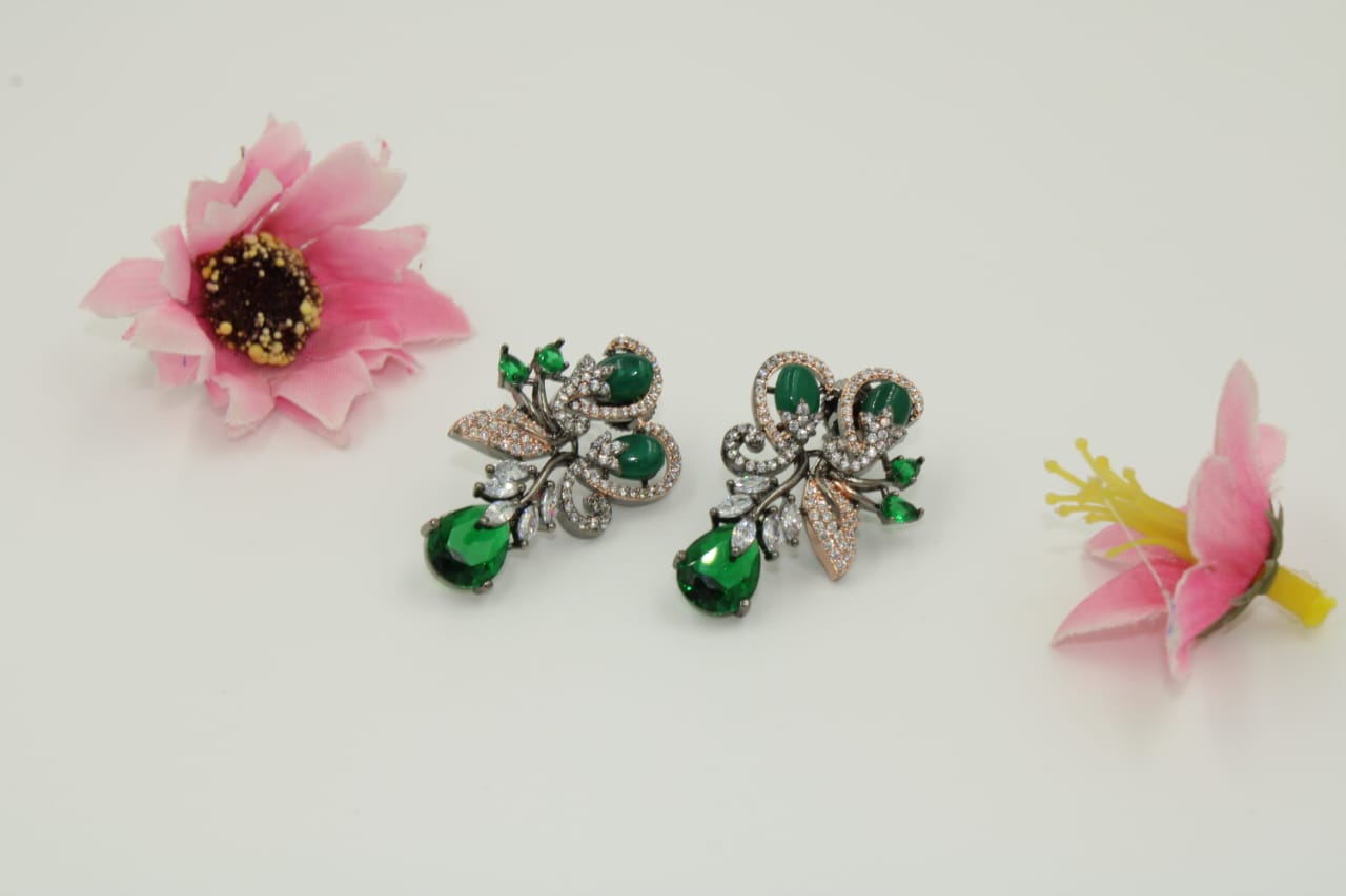 Fancy stud earring with dark green stones