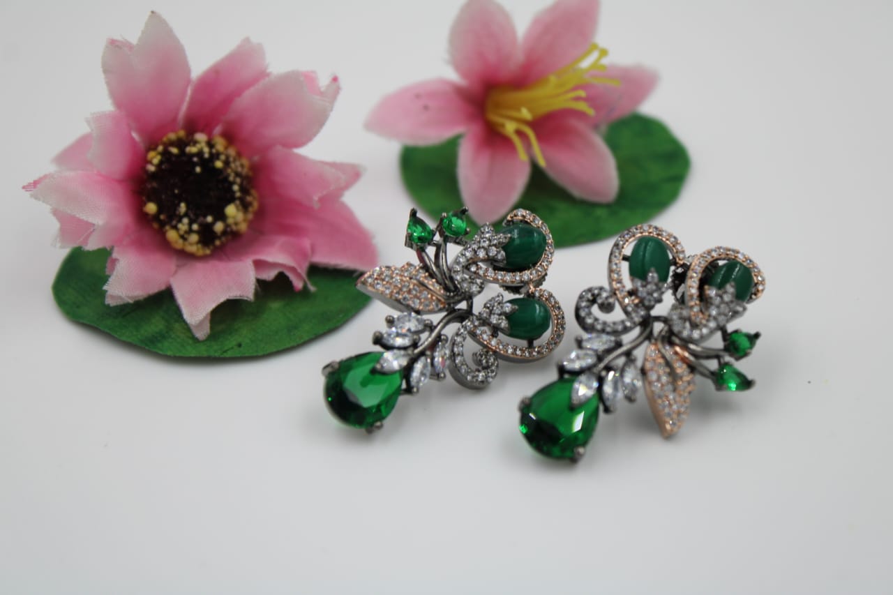 Fancy stud earring with dark green stones